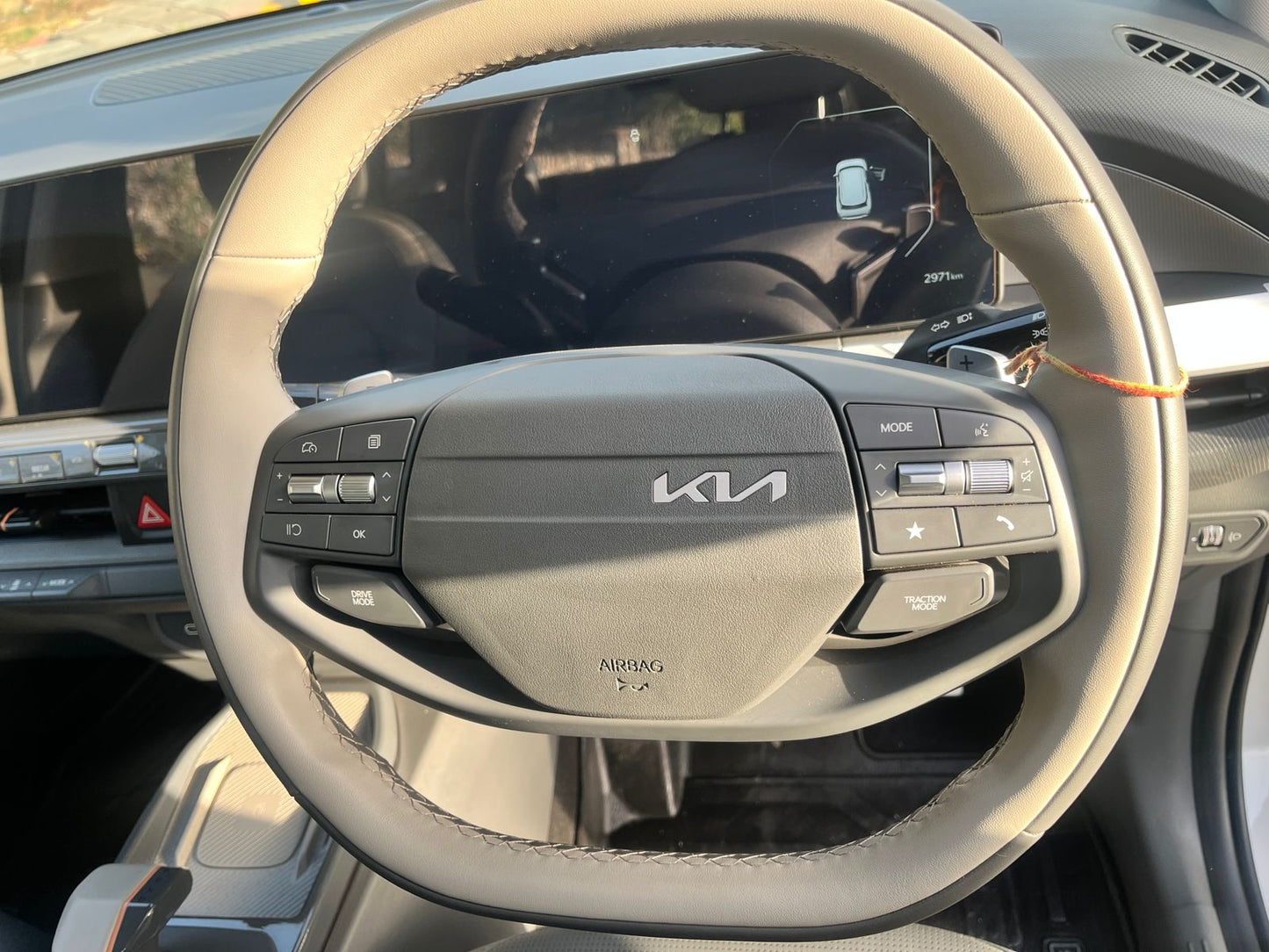 Steering wheel of a Kia car with visible logo