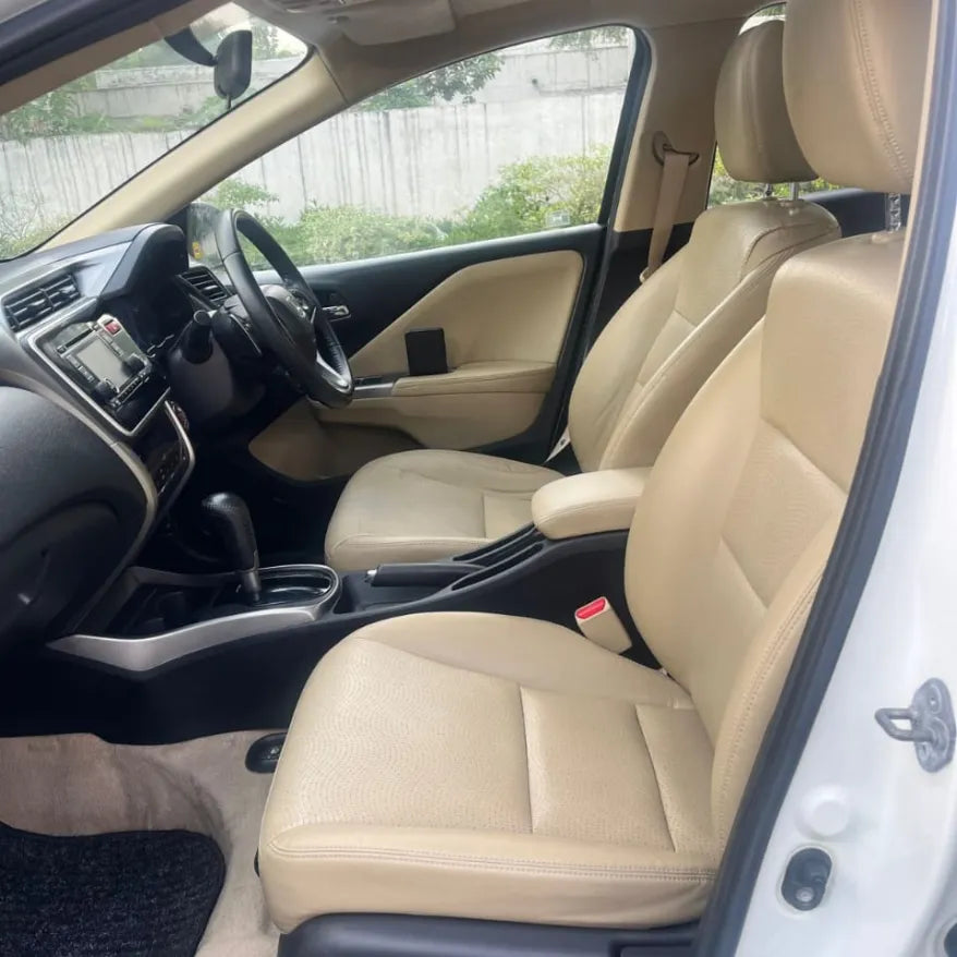 Car interior with beige seats and black dashboard