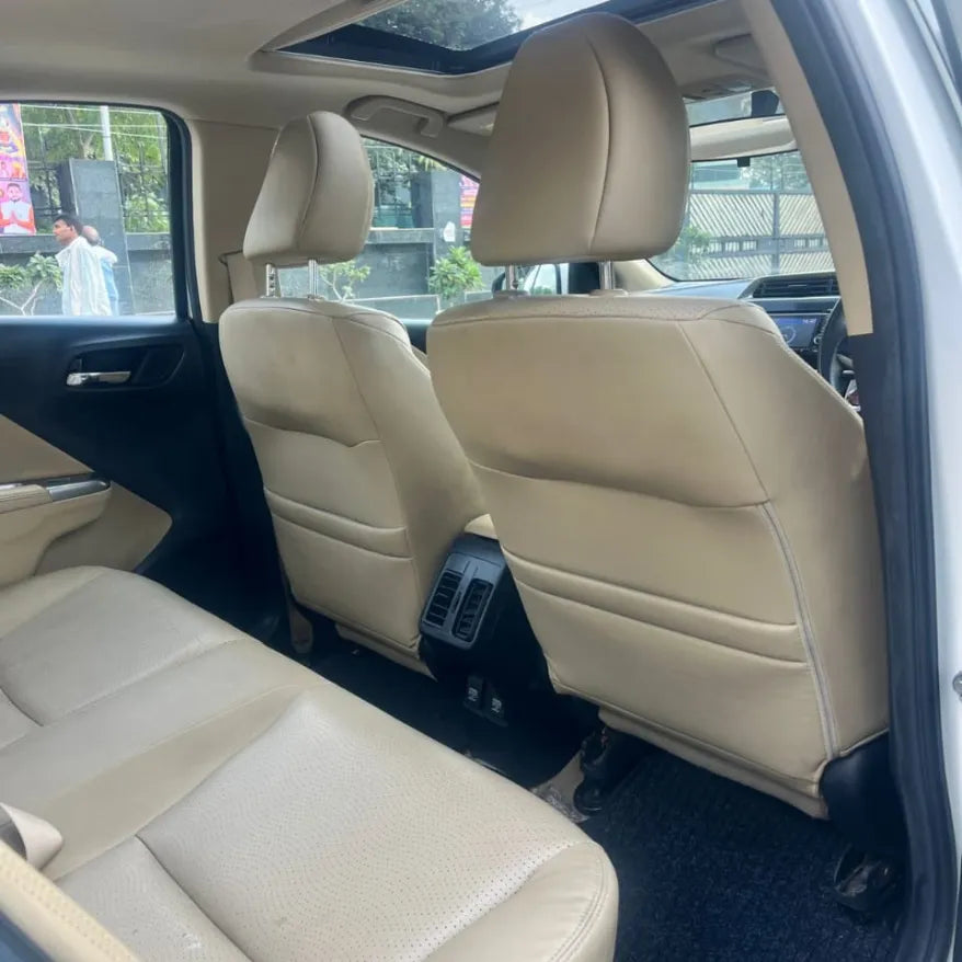 Beige car interior with visible seats and dashboard.