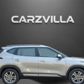 Silver SUV parked in front of a black background with 'CARZVILLA' branding.