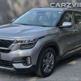 Silver SUV parked on a paved surface with a blurred background