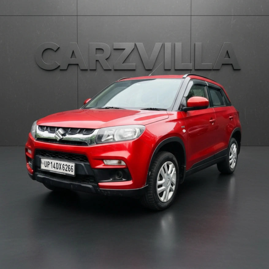 Red SUV parked in front of a gray wall with 'CARZVILLA' branding.