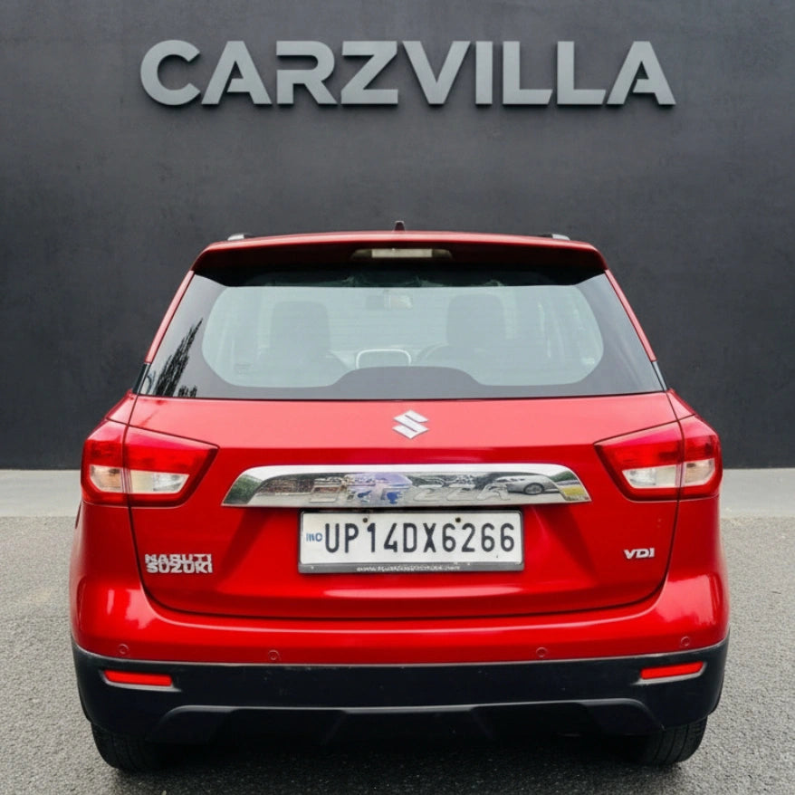 Red SUV with visible license plate in front of a black background with 'CARZVILLA' branding.