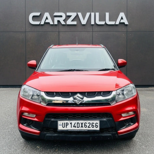Red SUV in front of a gray wall with 'CARZVILLA' branding