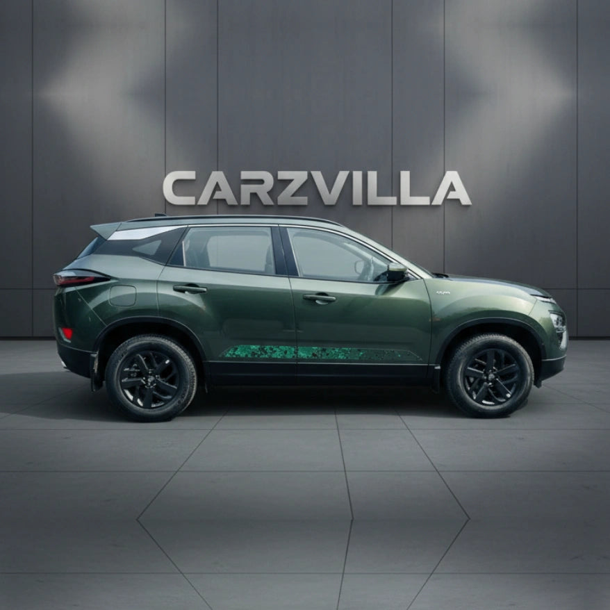 Green SUV parked in front of a gray wall with 'CARZVILLA' branding.
