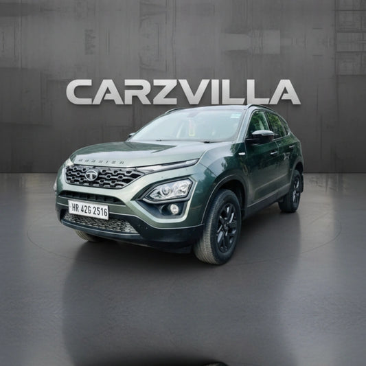 Green SUV on a gray floor with 'CARZVILLA' branding in the background