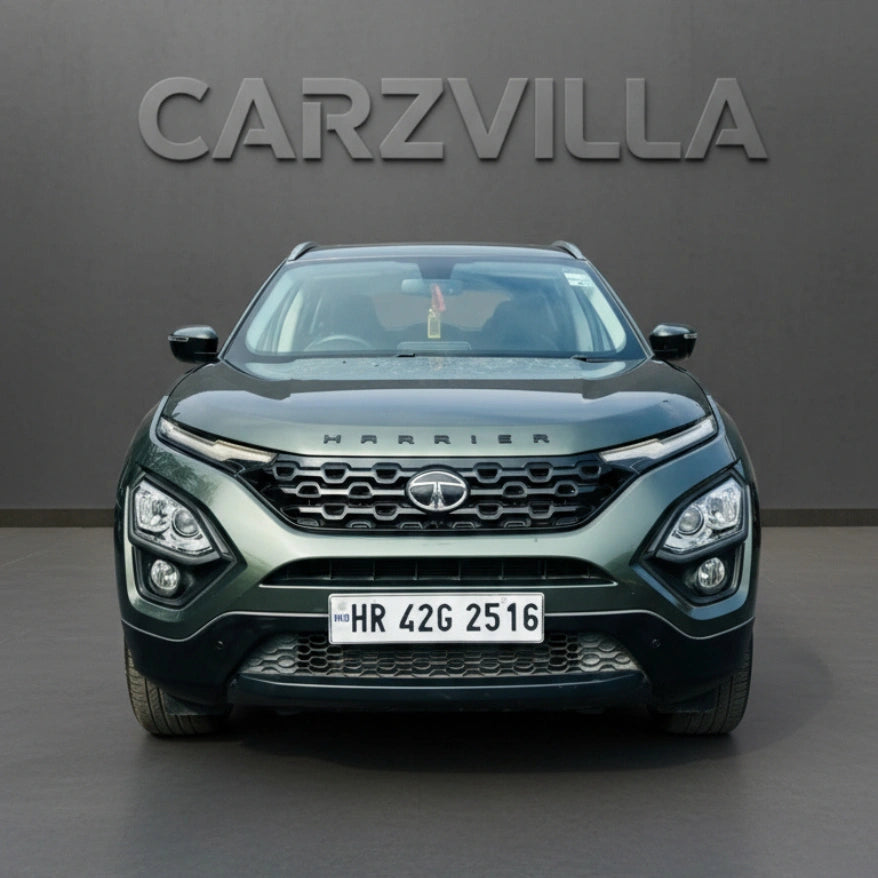 Green Tata Harrier SUV with 'CARZVILLA' branding on a gray background