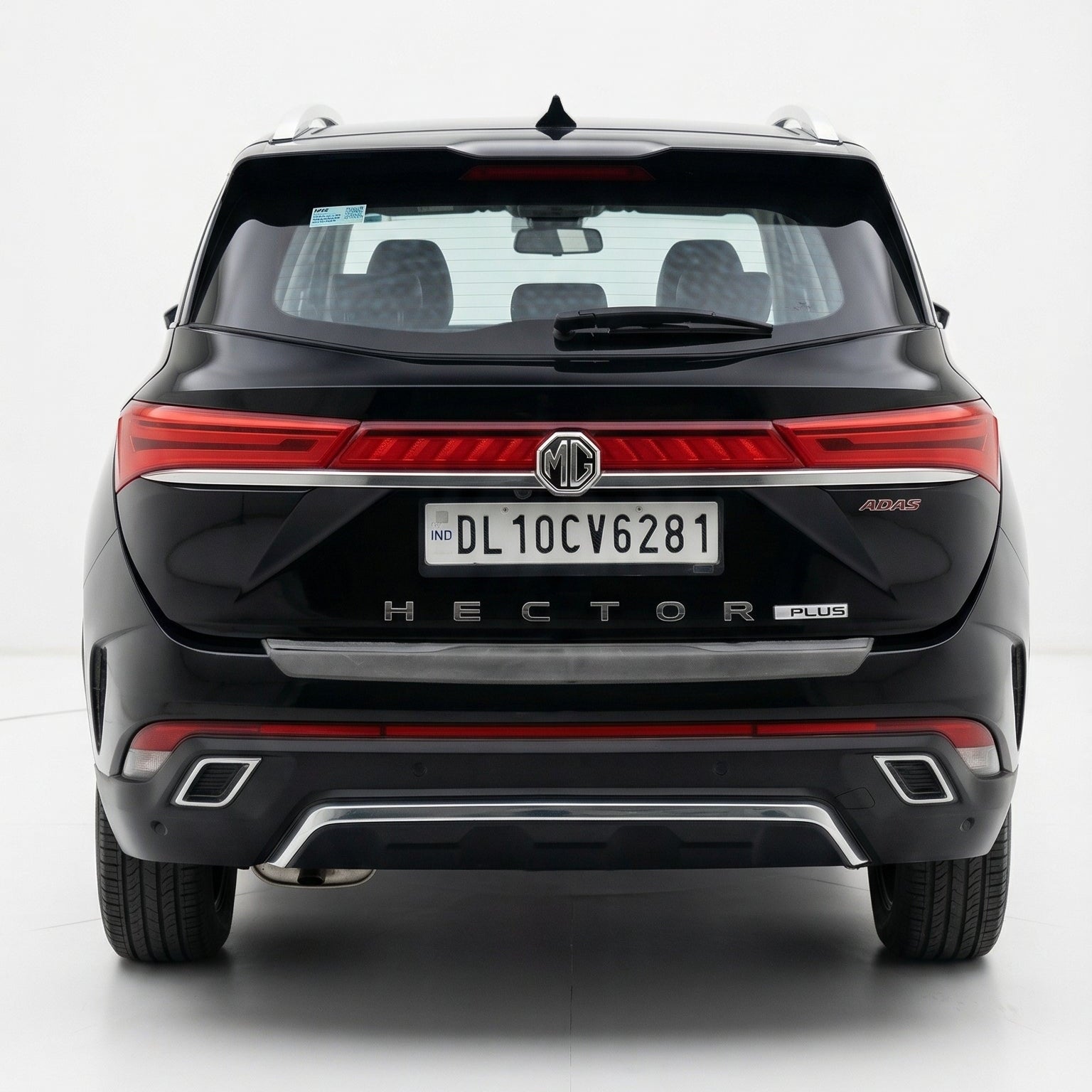 Back view of a black SUV with red accents on a white background