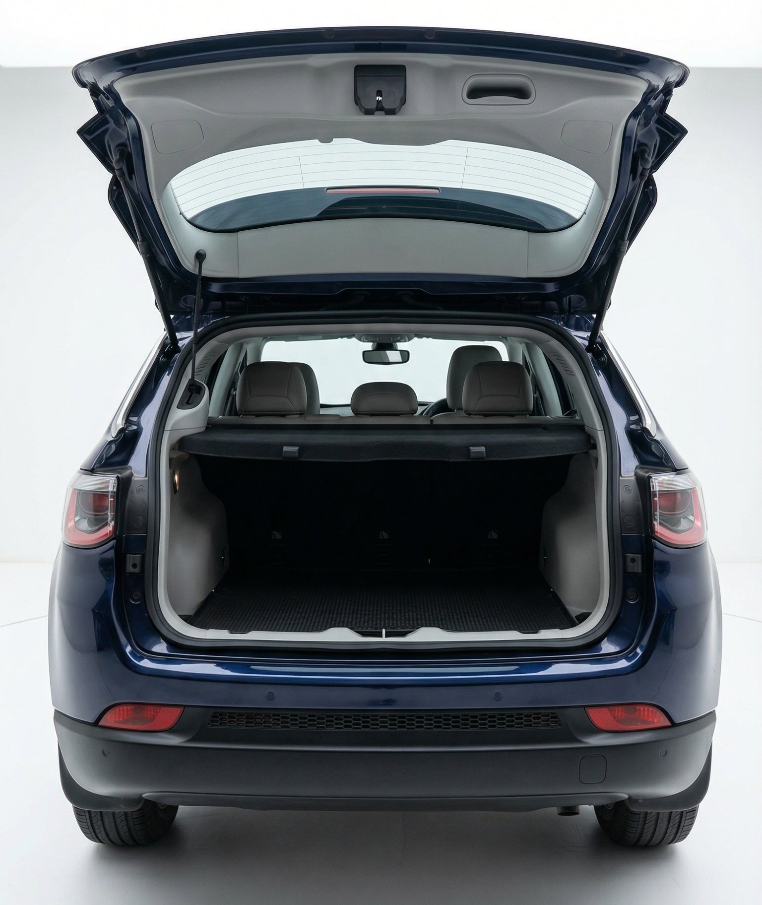 Blue car with open trunk on a white background
