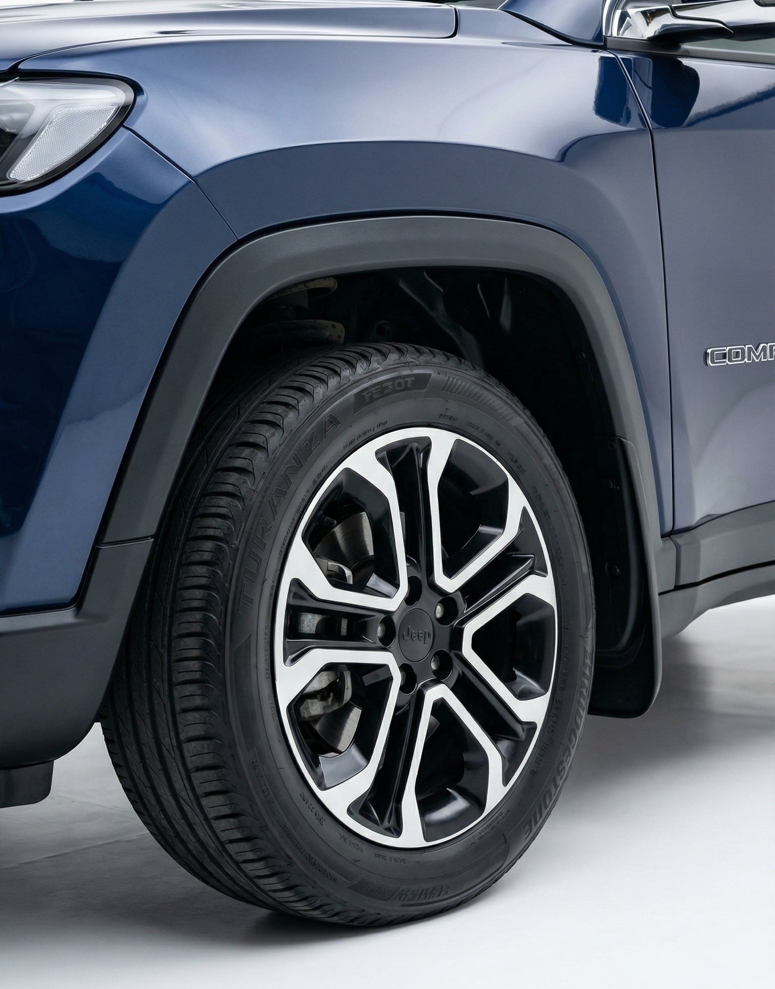 Close-up of a blue SUV tire on a white background