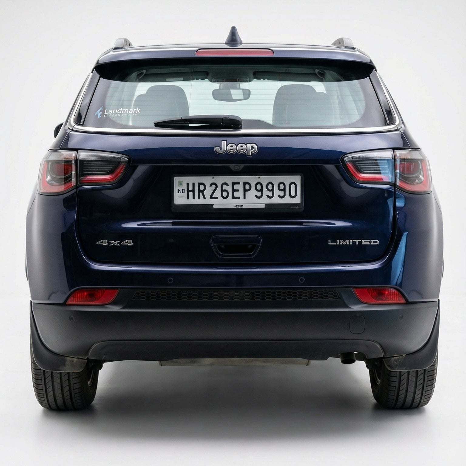 Back view of a blue Jeep car on a white background