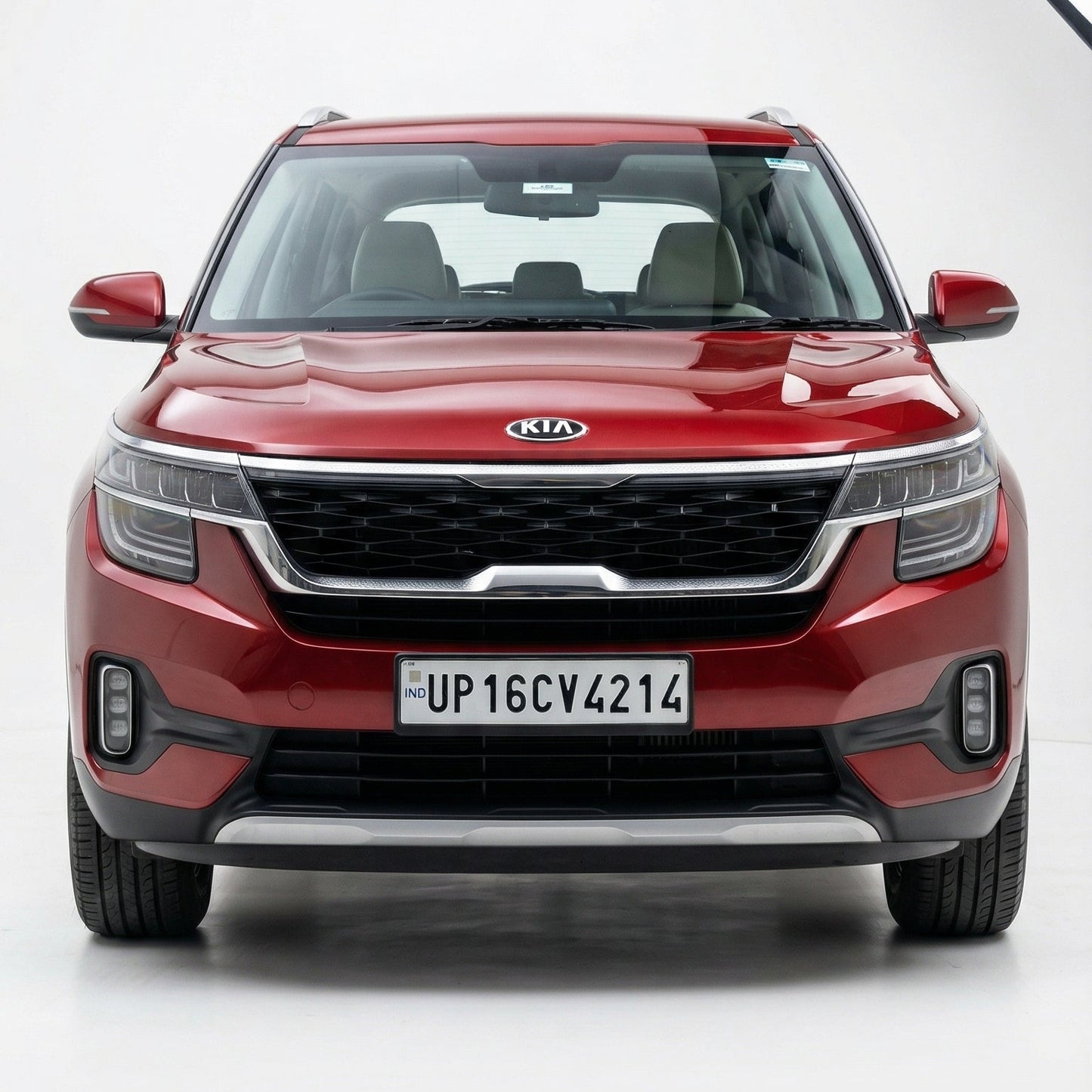 Red Kia SUV on a white background