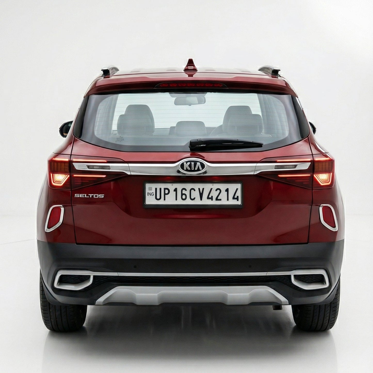 Red Kia SUV shown from a rear three-quarter angle on a white background