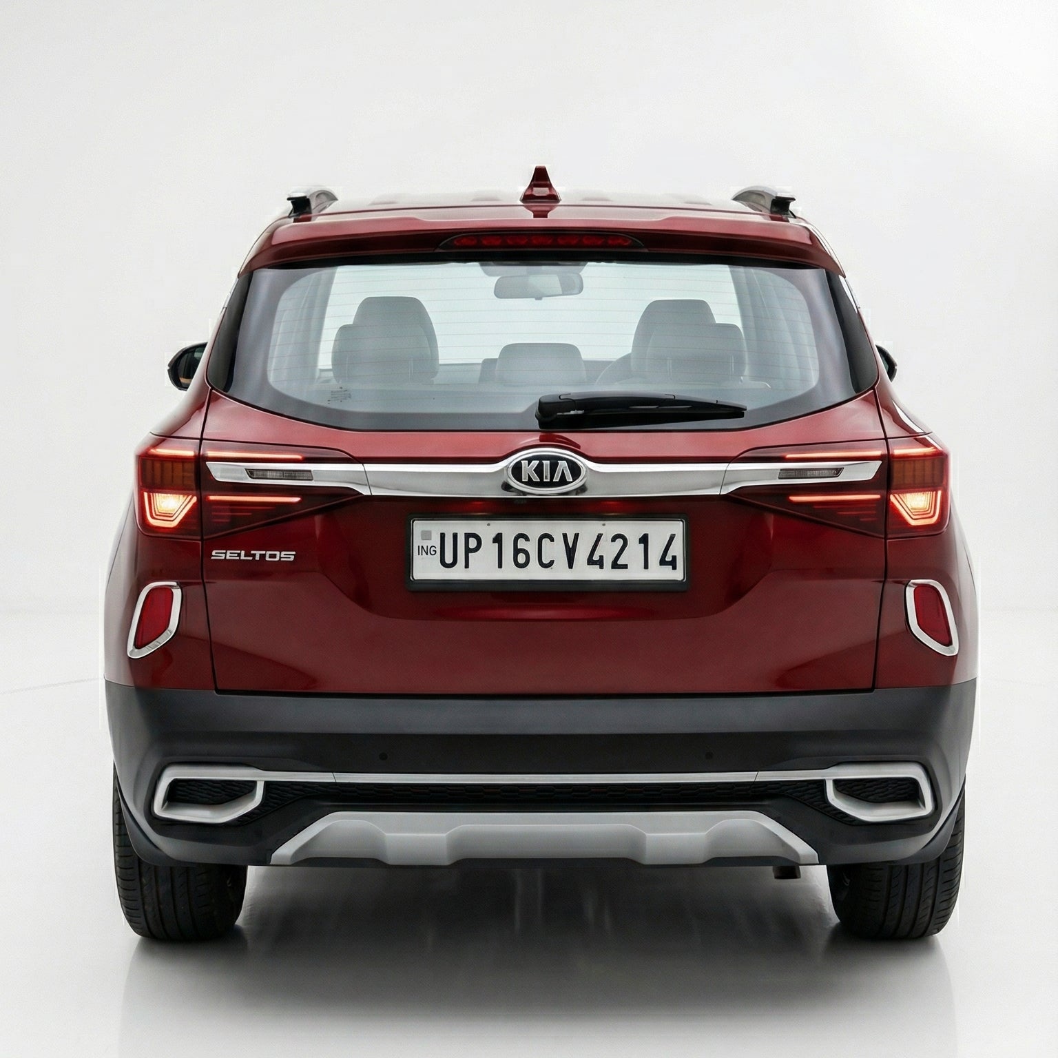 Red Kia SUV shown from a rear three-quarter angle on a white background