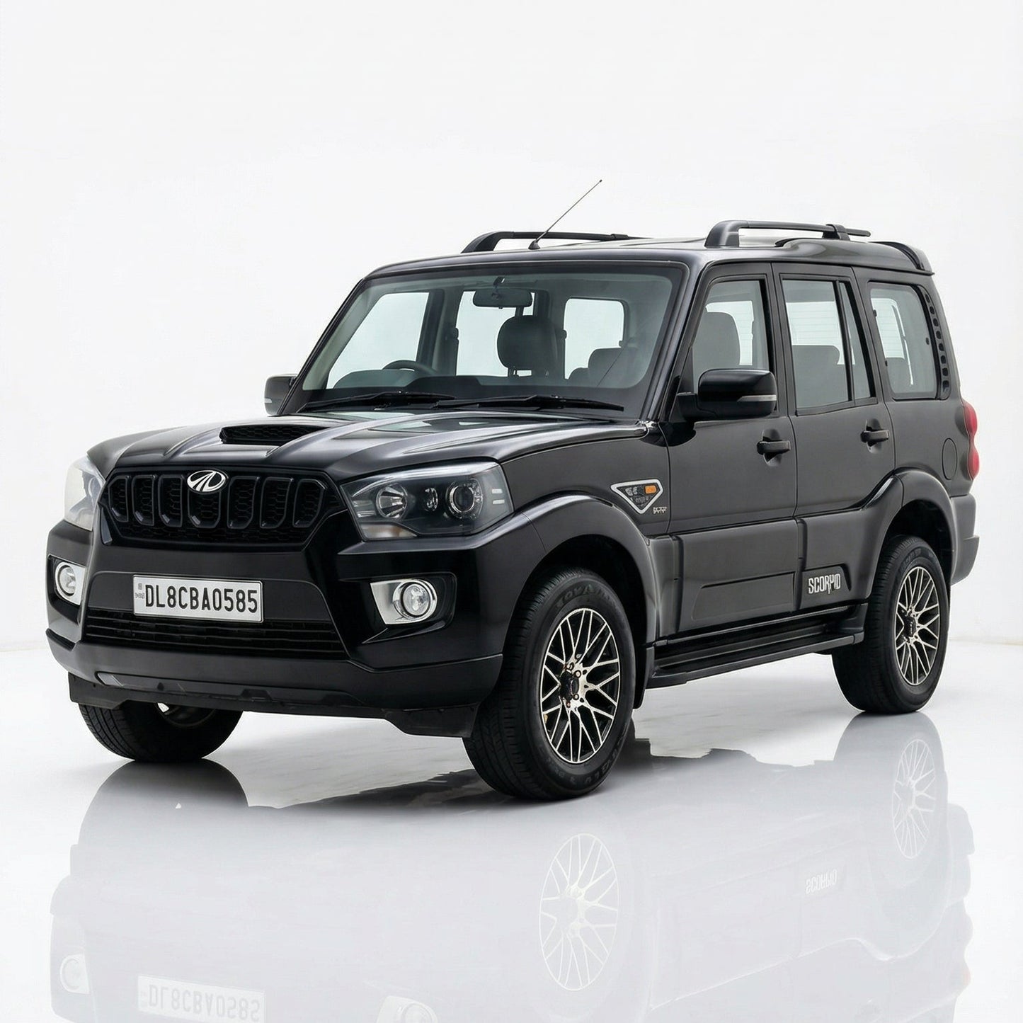 Black SUV on a reflective white surface with a white background
