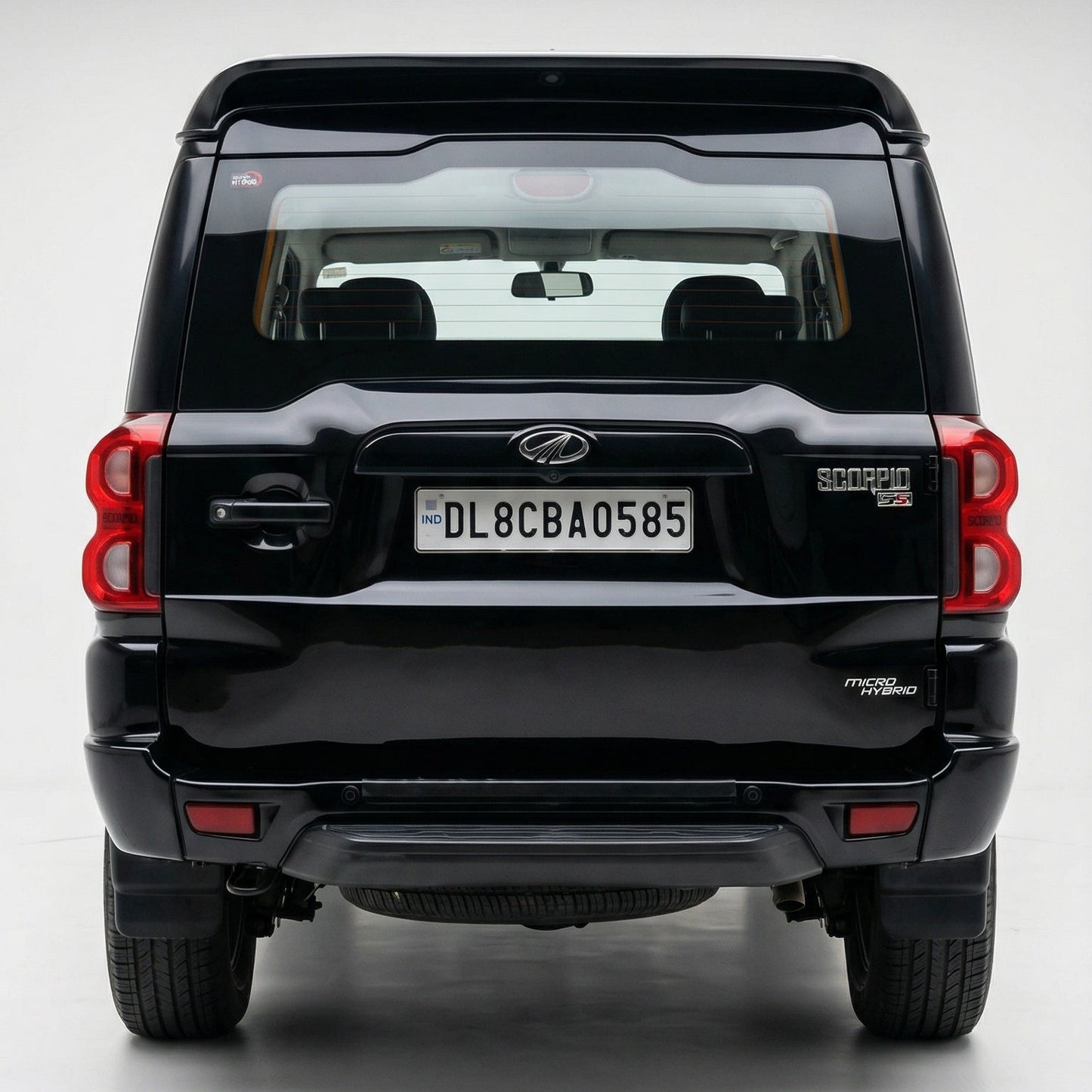 Black SUV with a visible license plate on a white background