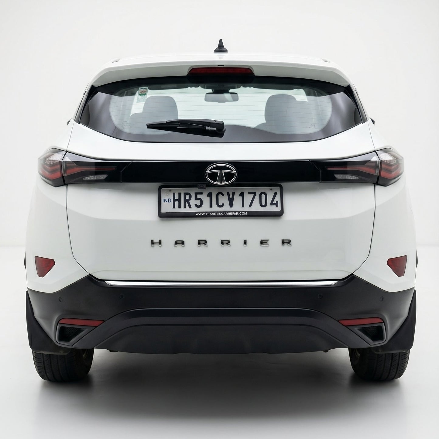 White SUV with 'Harrier' branding on a white background