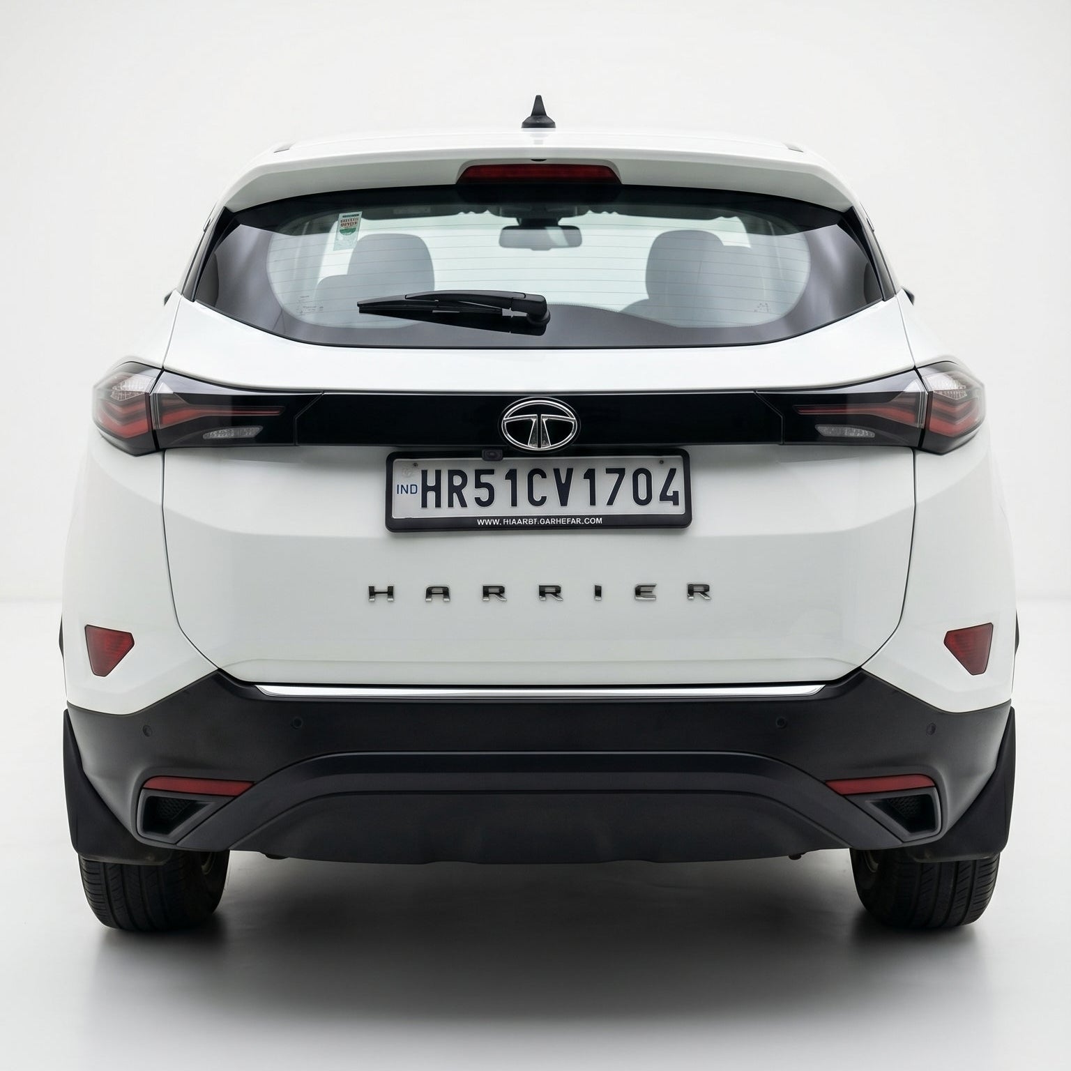 White SUV with 'Harrier' branding on a white background