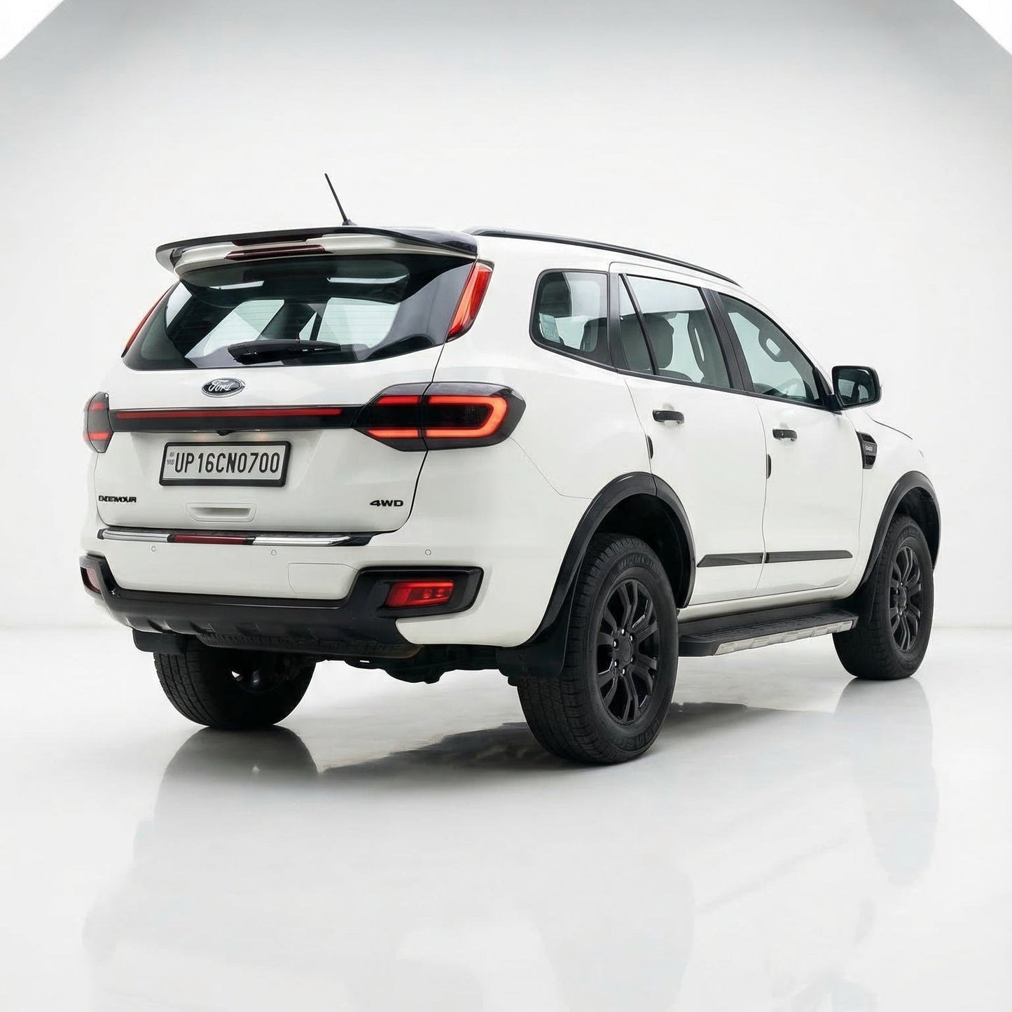 White SUV with black accents on a reflective white surface