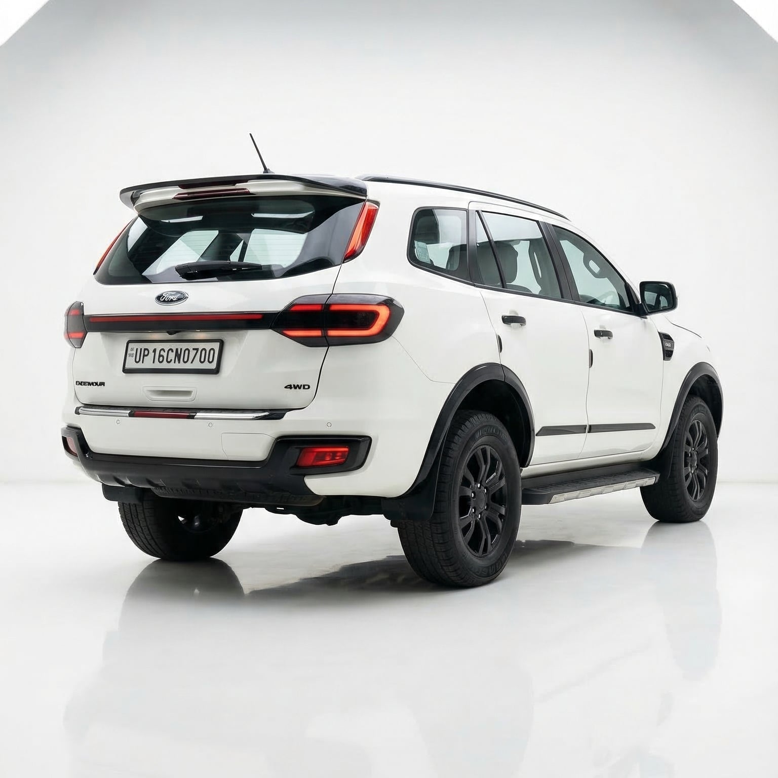 White SUV with black accents on a reflective white surface