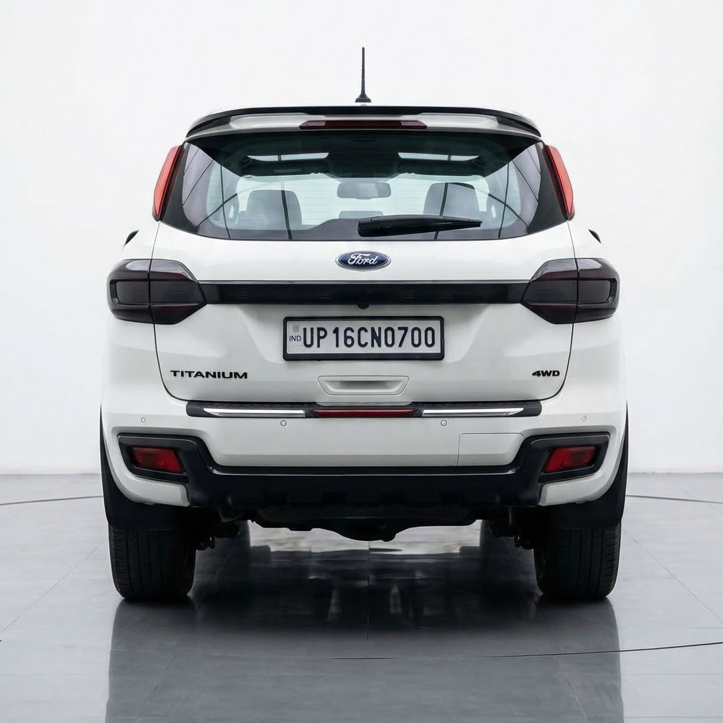 White Ford EcoSport on a reflective surface with a white background