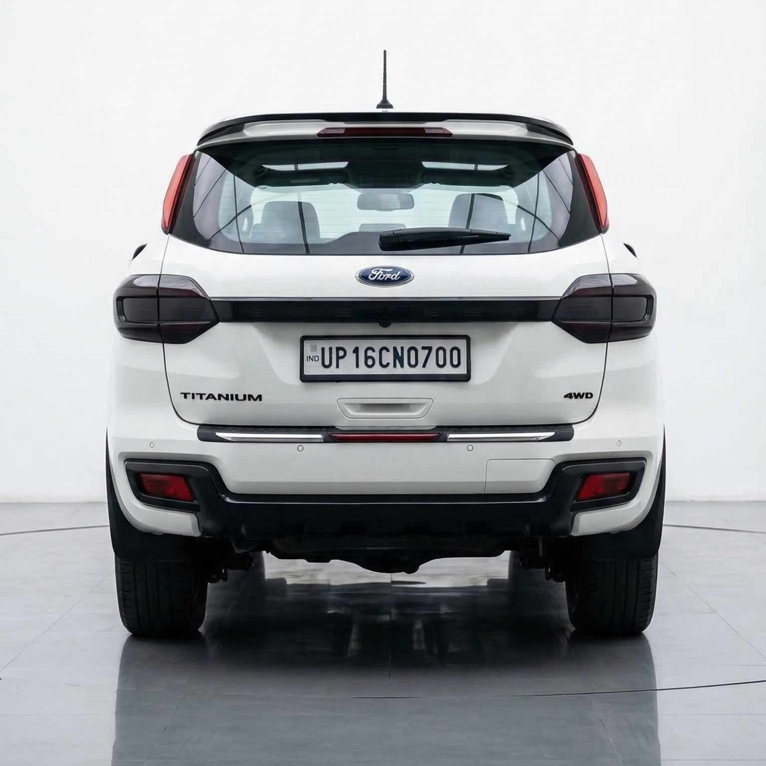 White Ford EcoSport on a reflective surface with a white background