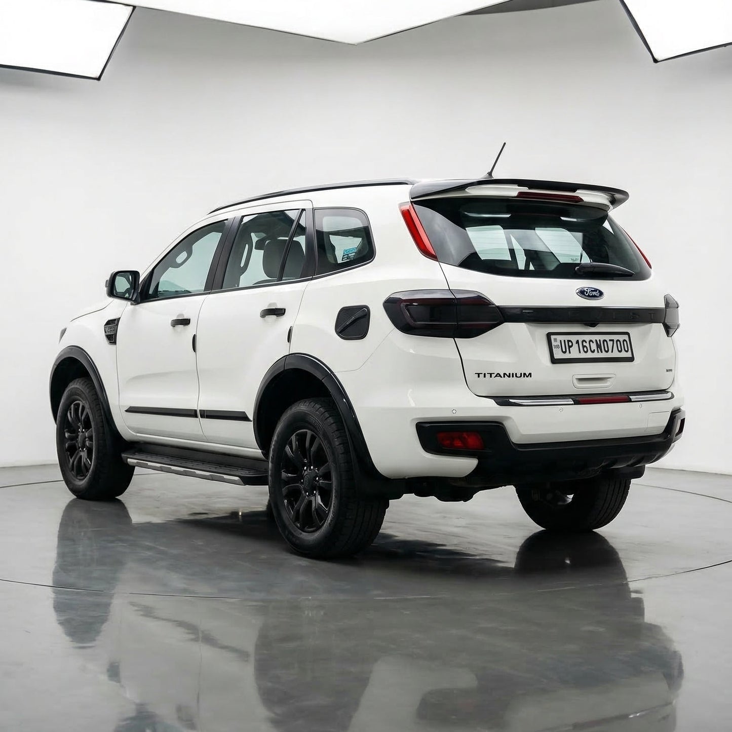 White Ford Ranger Wildtrak SUV on a reflective surface with a white background