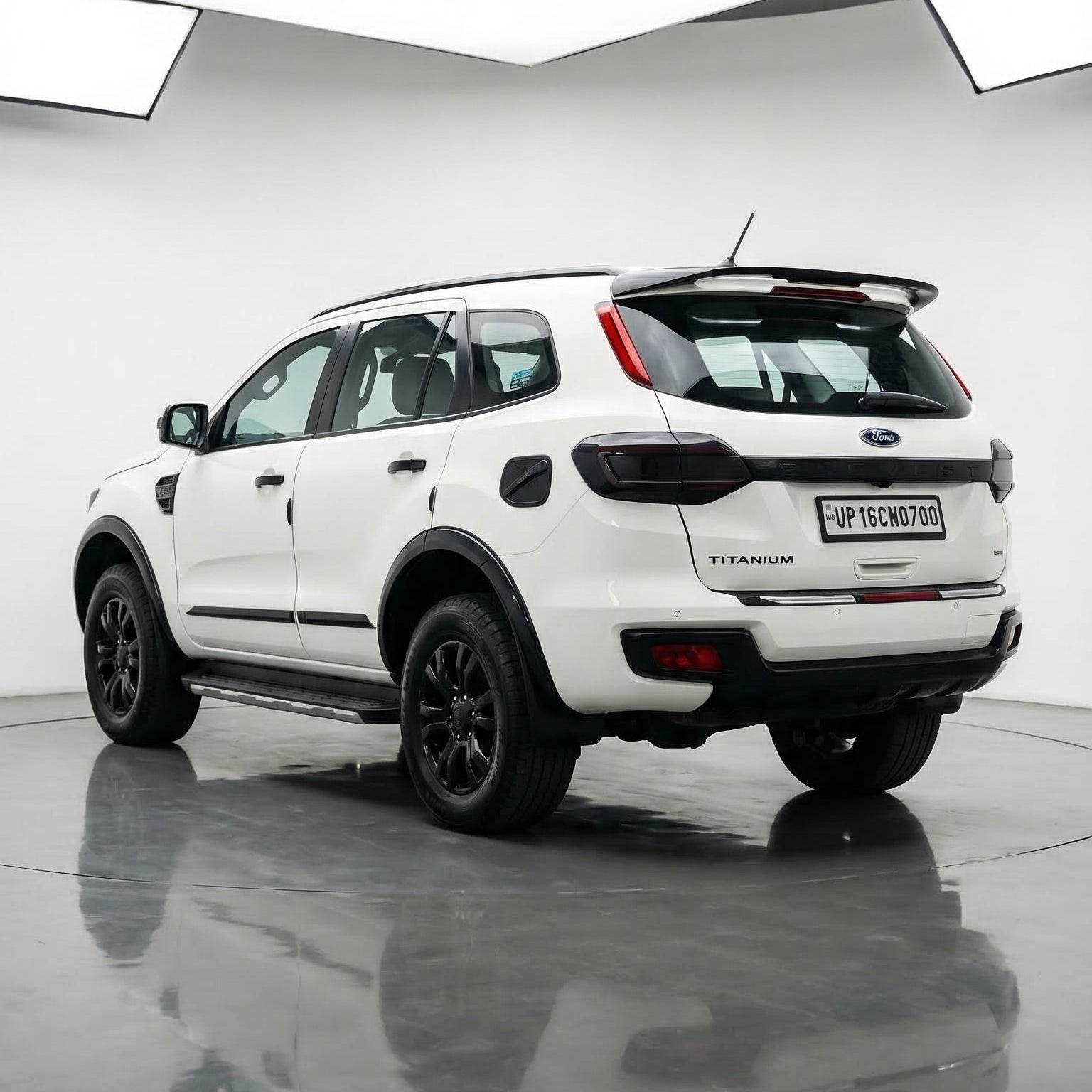 White Ford Ranger Wildtrak SUV on a reflective surface with a white background