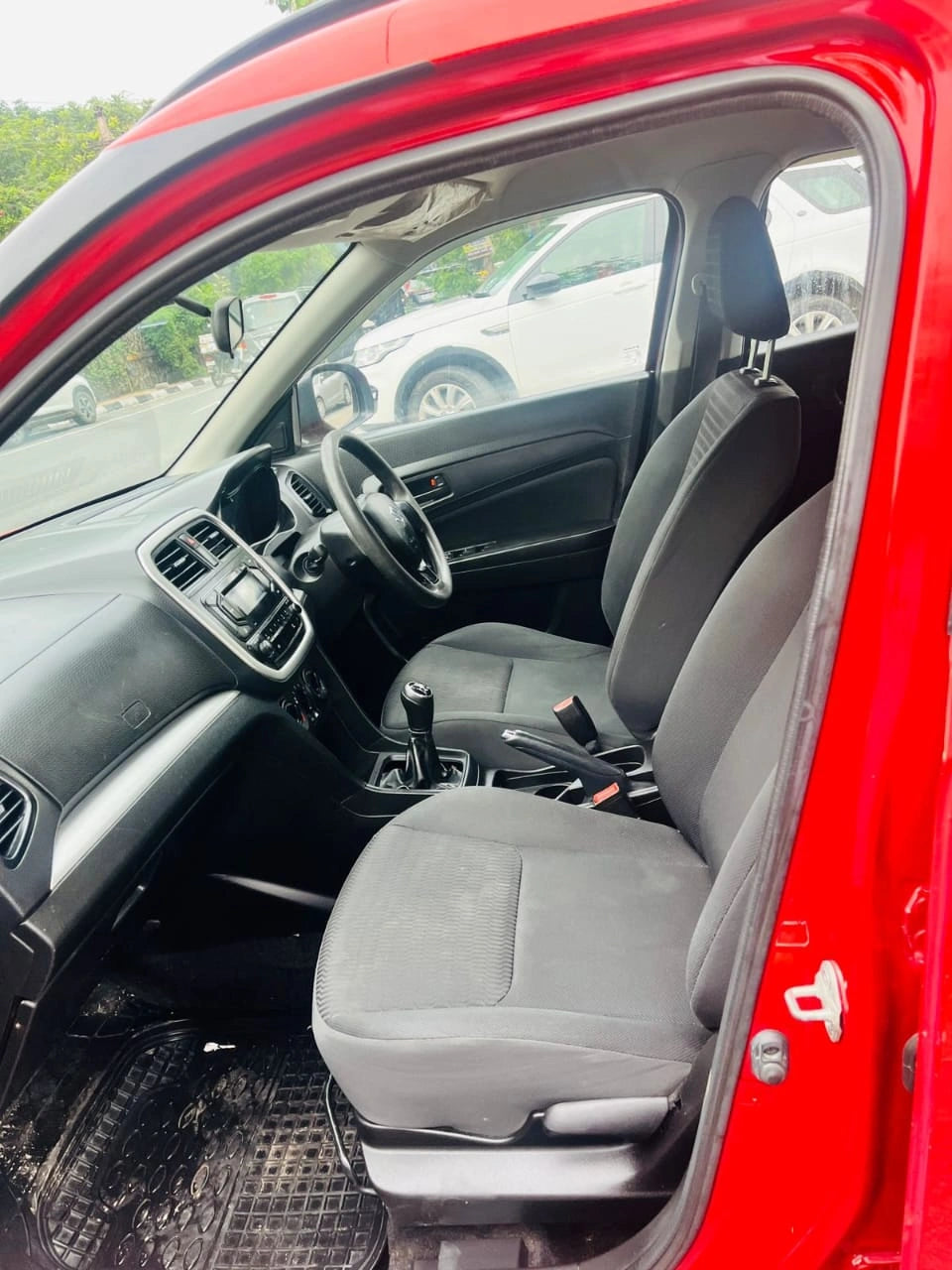 Red car interior with gray seats and dashboard.