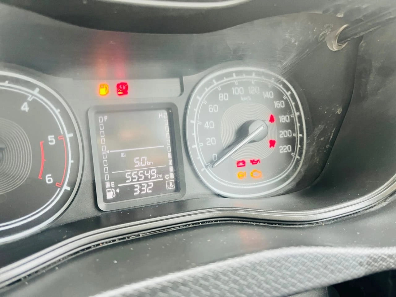 Car dashboard with speedometer and digital display showing vehicle information.