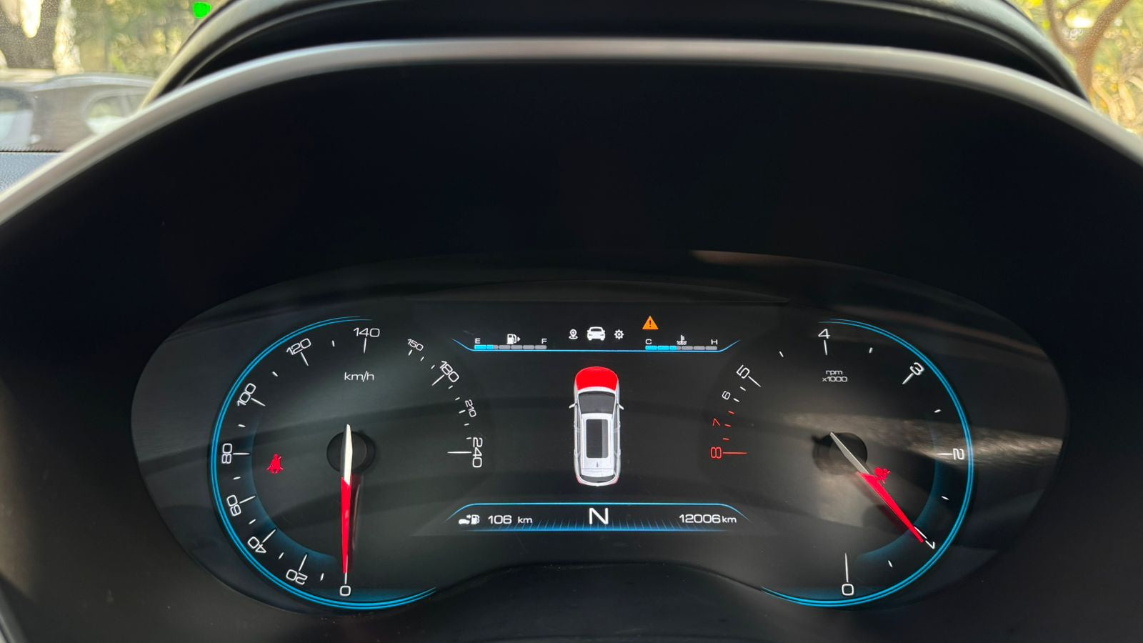 Car dashboard with digital display and various indicators.