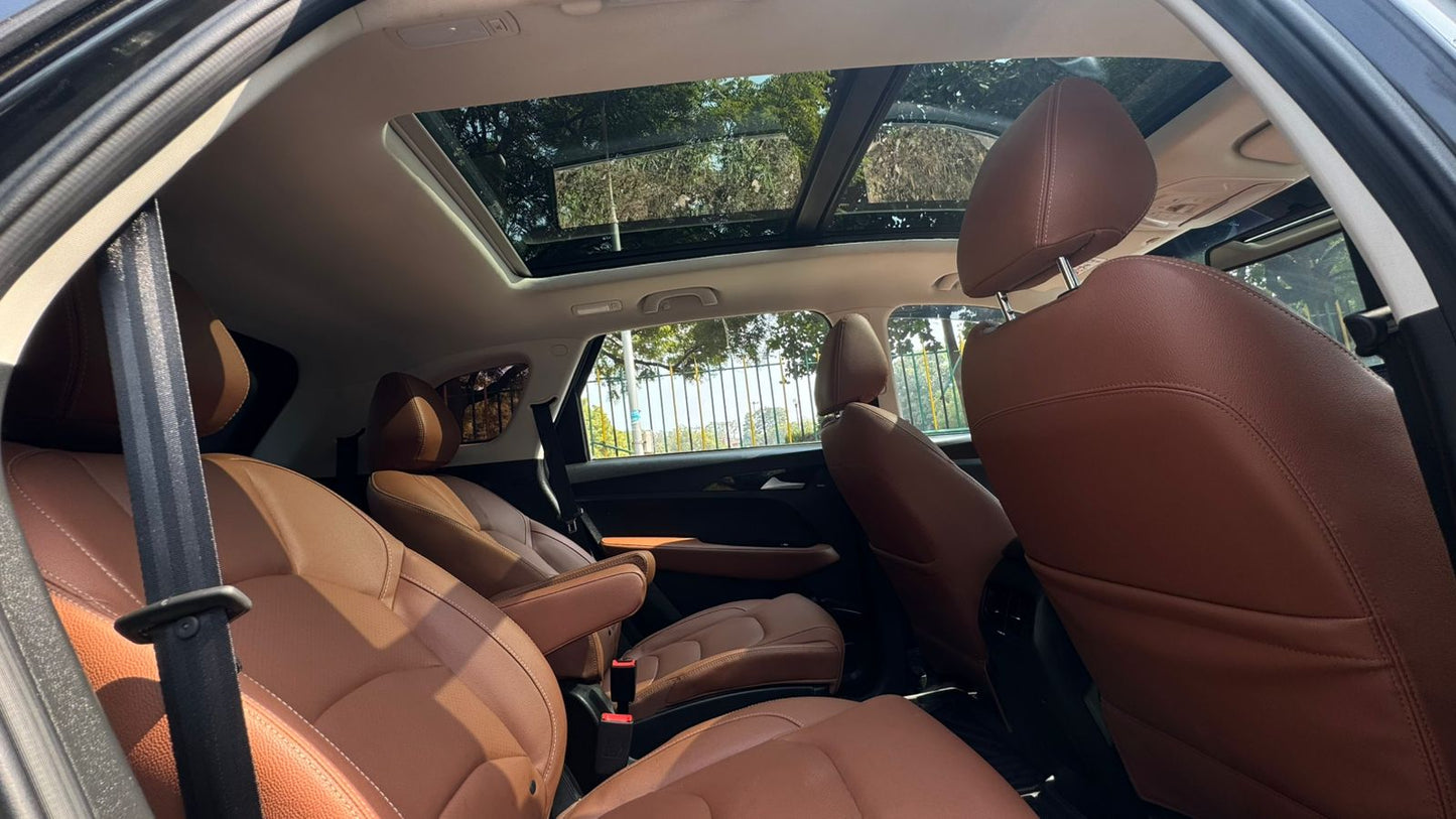 Brown leather interior of a car with a sunroof