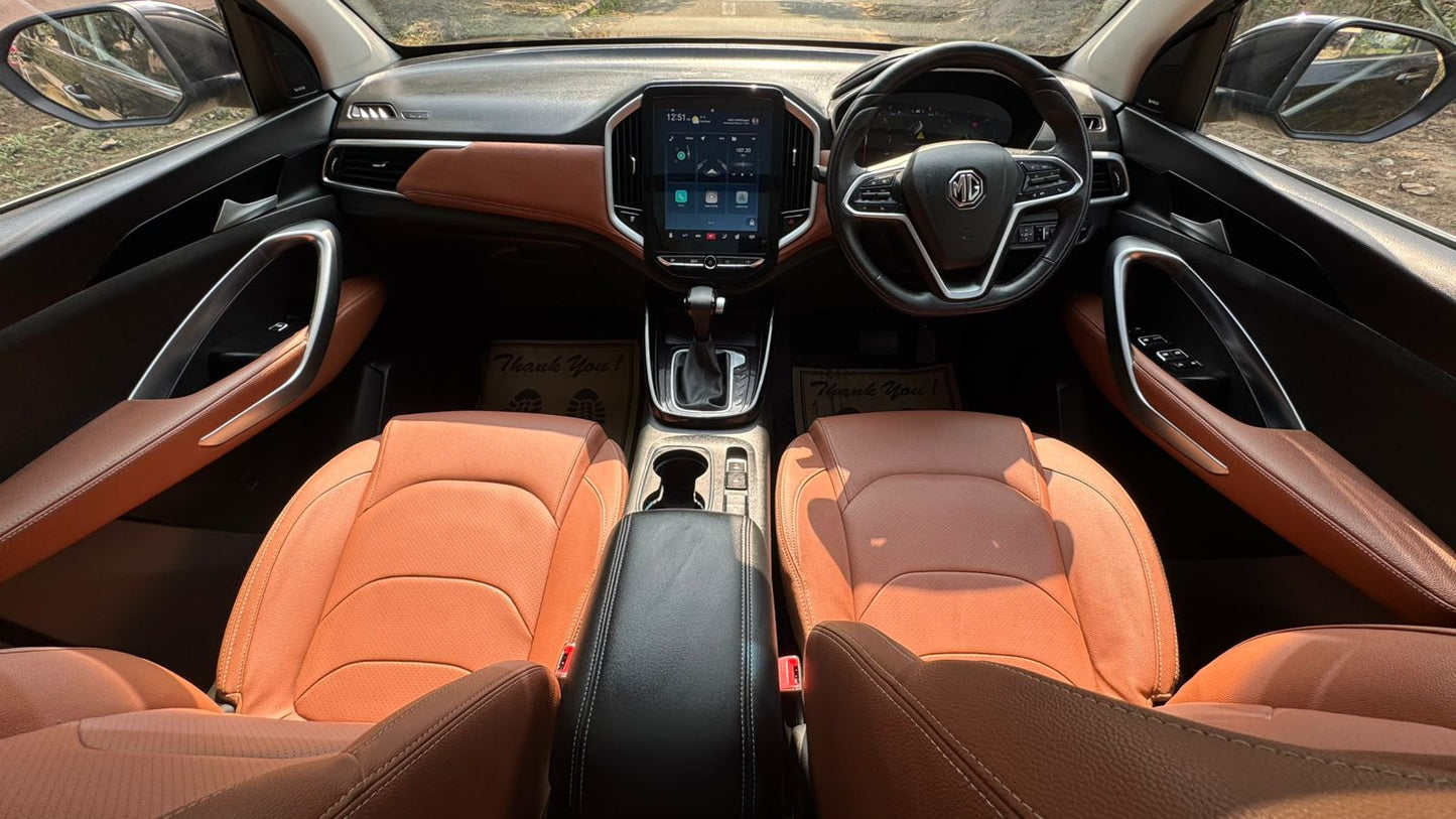 Car interior with orange leather seats and a modern dashboard.