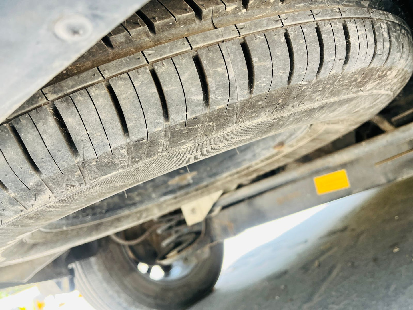 Close-up of a car tire with visible tread pattern