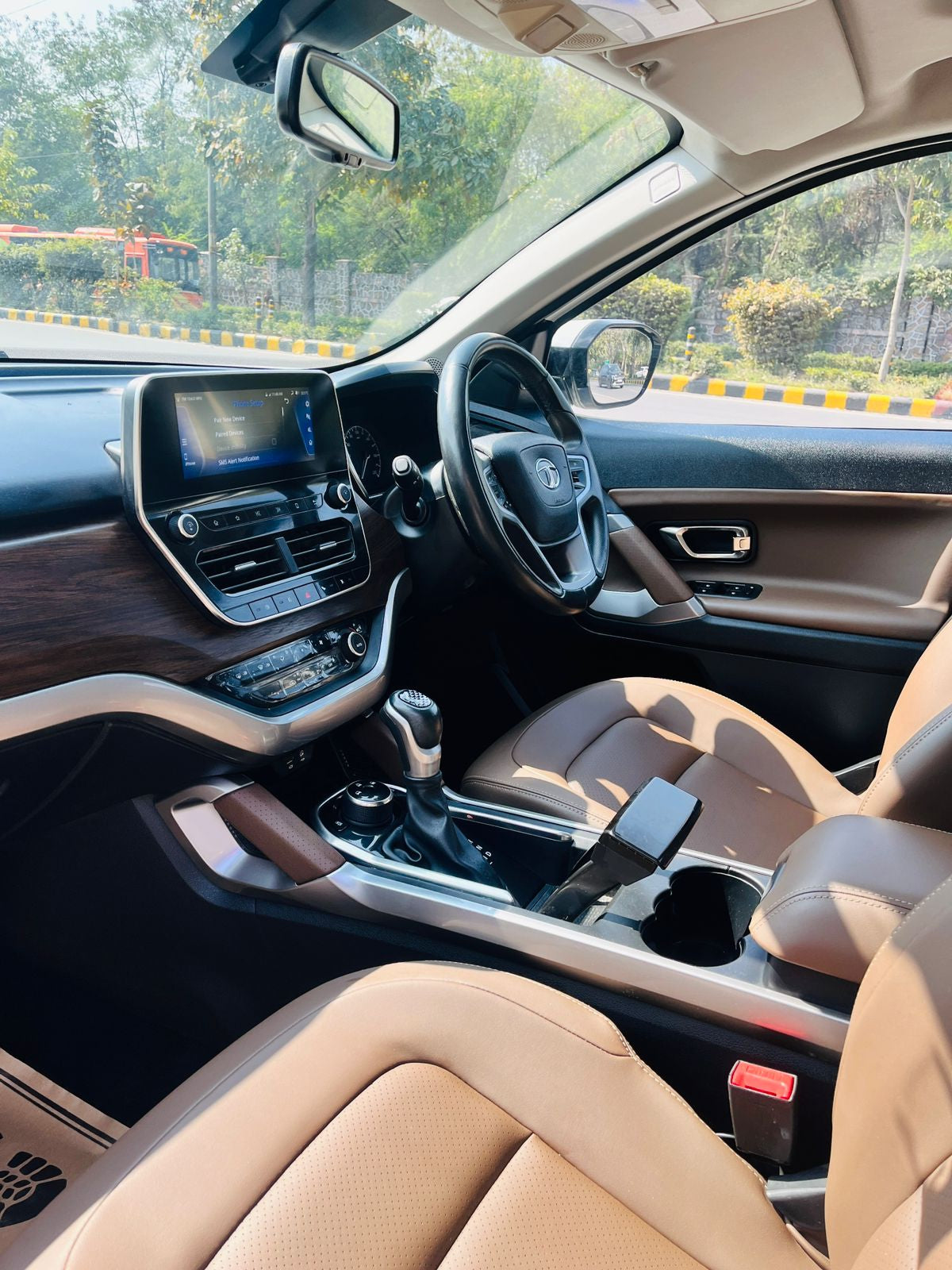 Car interior with dashboard, steering wheel, and seats.
