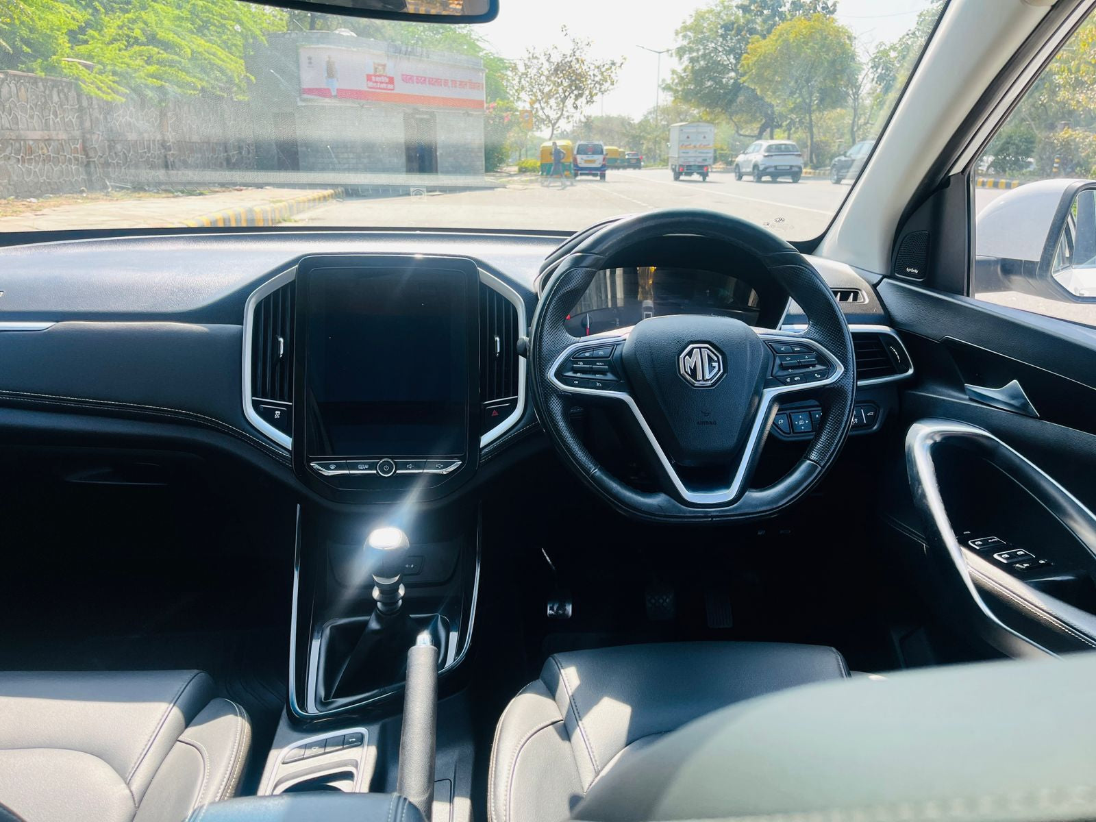 Car interior with MG logo on steering wheel