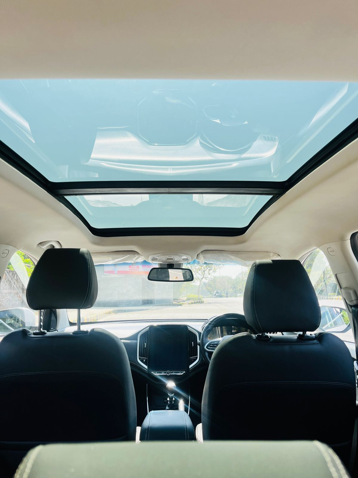 Car interior with a sunroof on a clear day