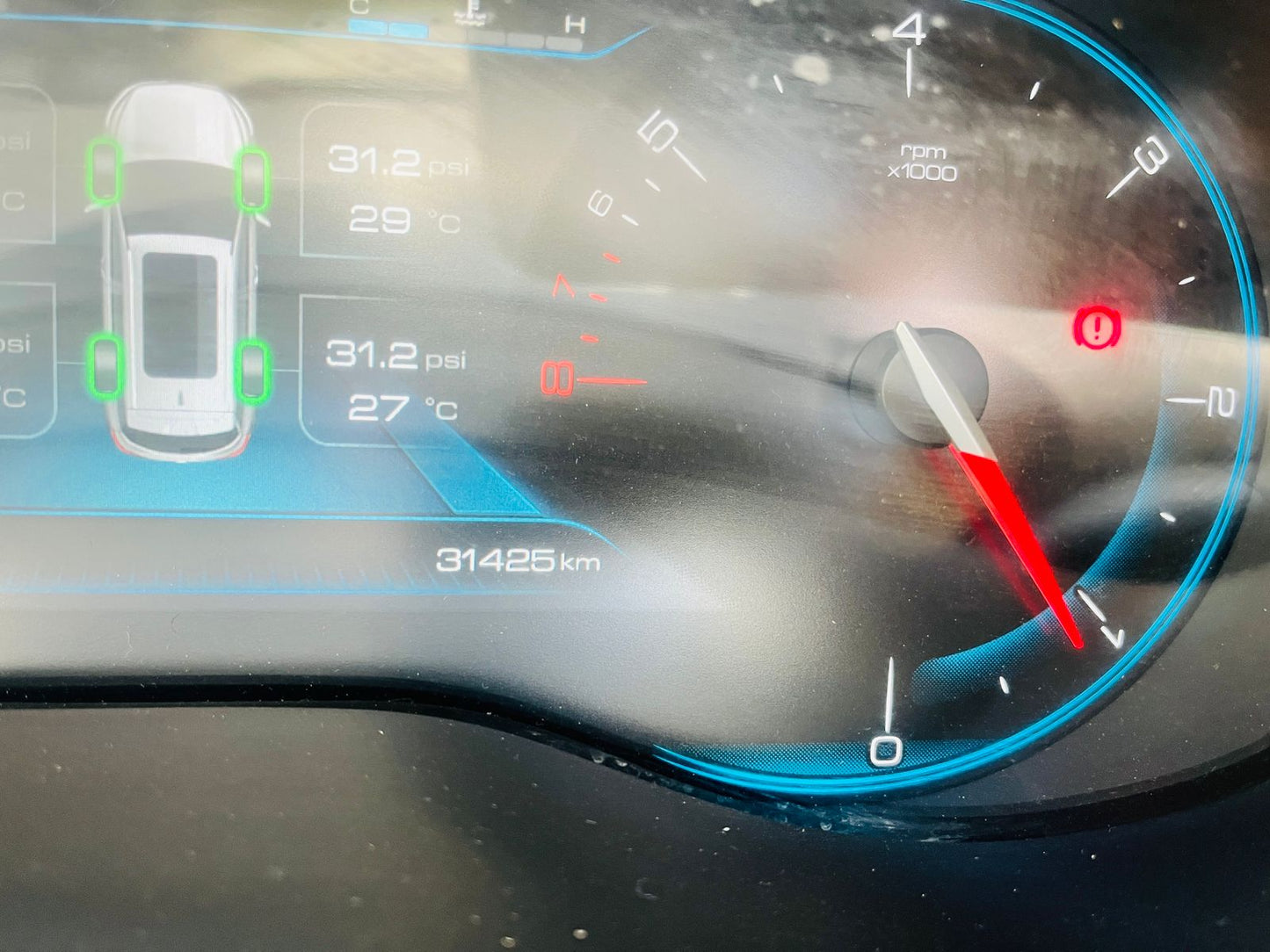 Car dashboard with digital display showing various metrics