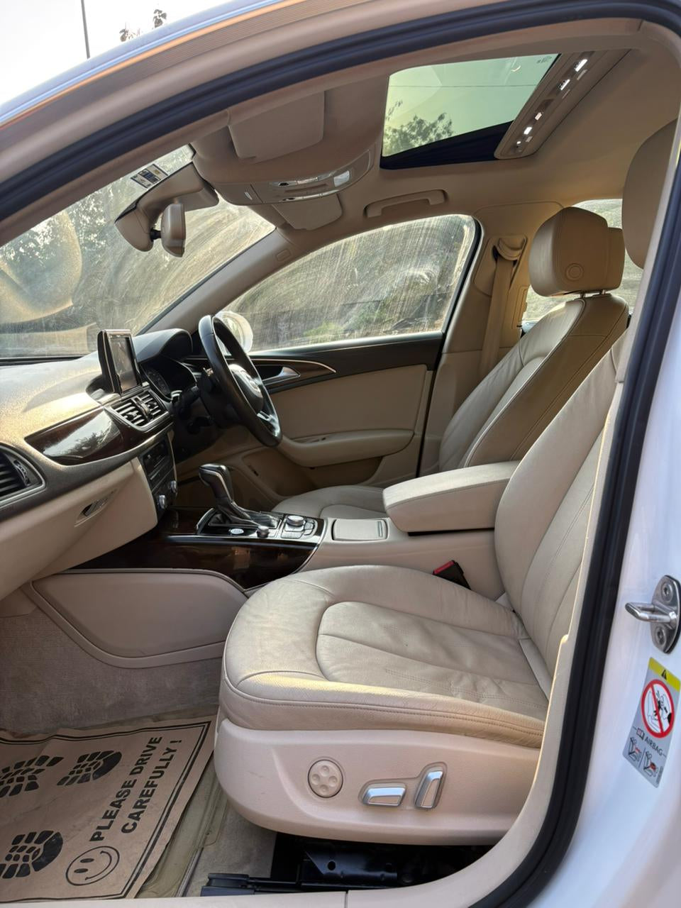 Beige interior of a car with visible door open