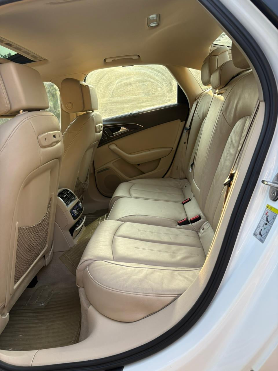 Beige interior of a car with visible seats and door panel.