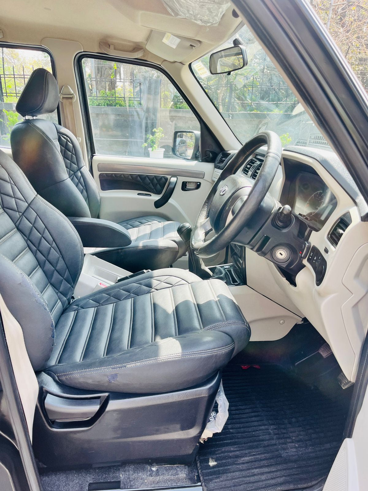 Car interior with quilted gray seats and steering wheel