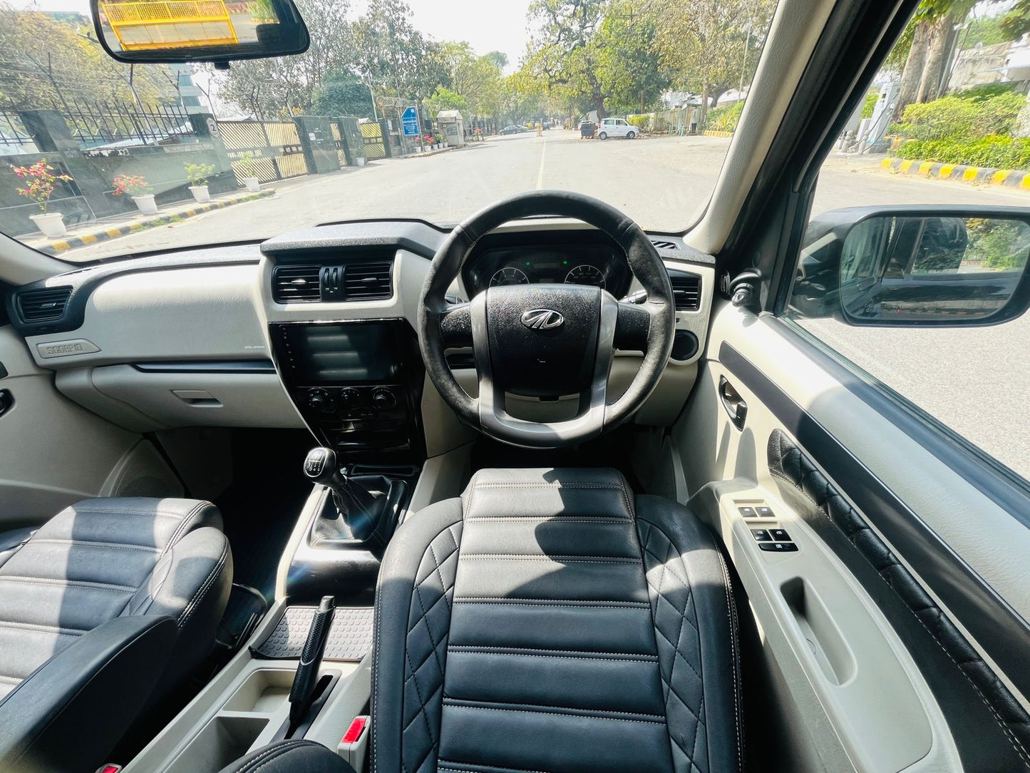 Car interior with steering wheel and dashboard view