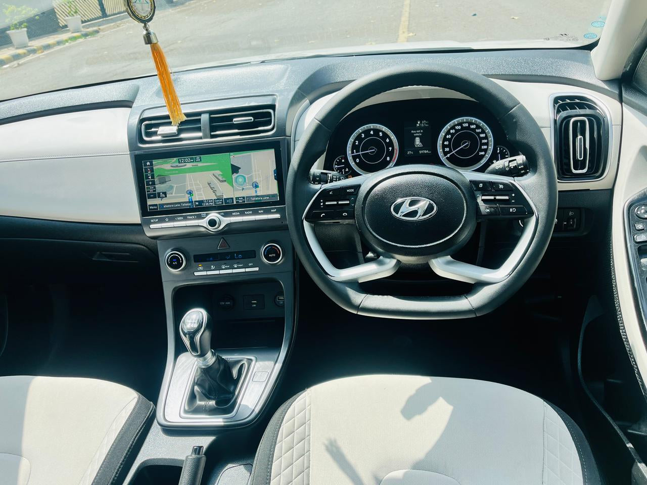 Car interior with dashboard, steering wheel, and navigation system.