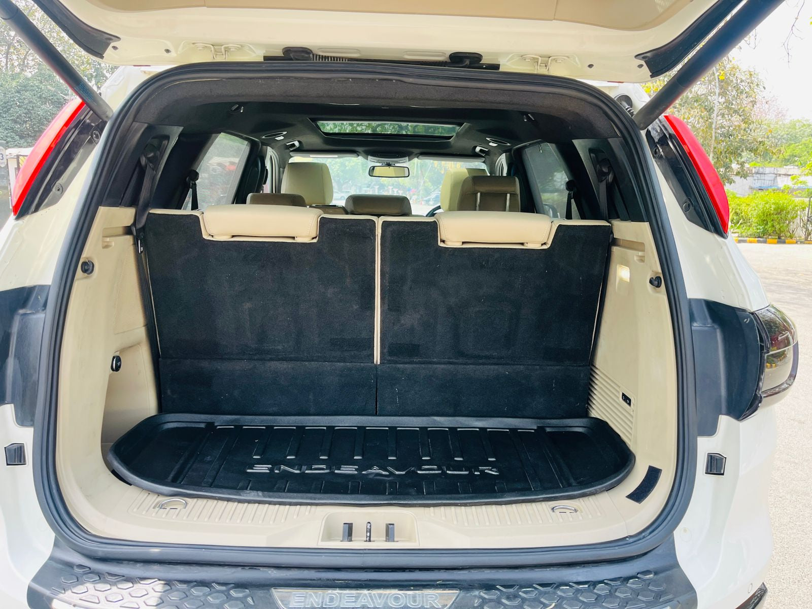 Open trunk of a car with folded seats in a parking lot