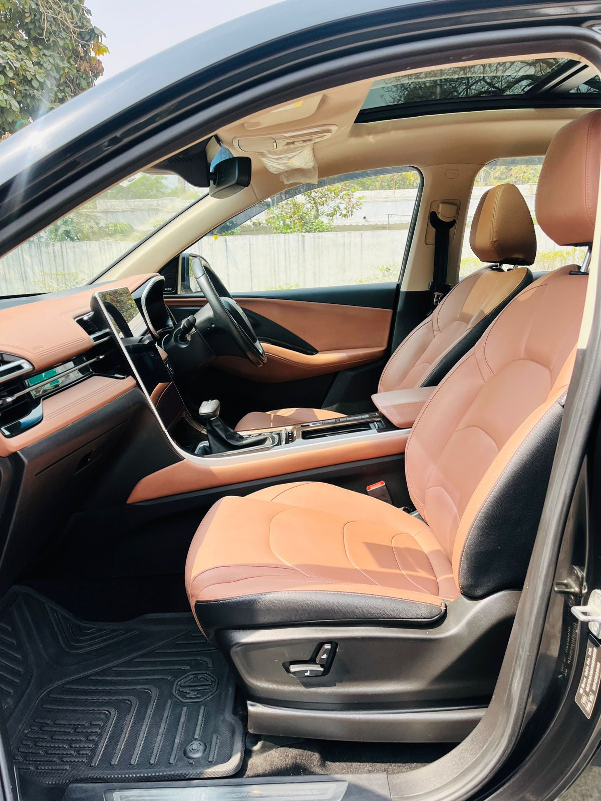 Car interior with brown leather seats and dashboard.