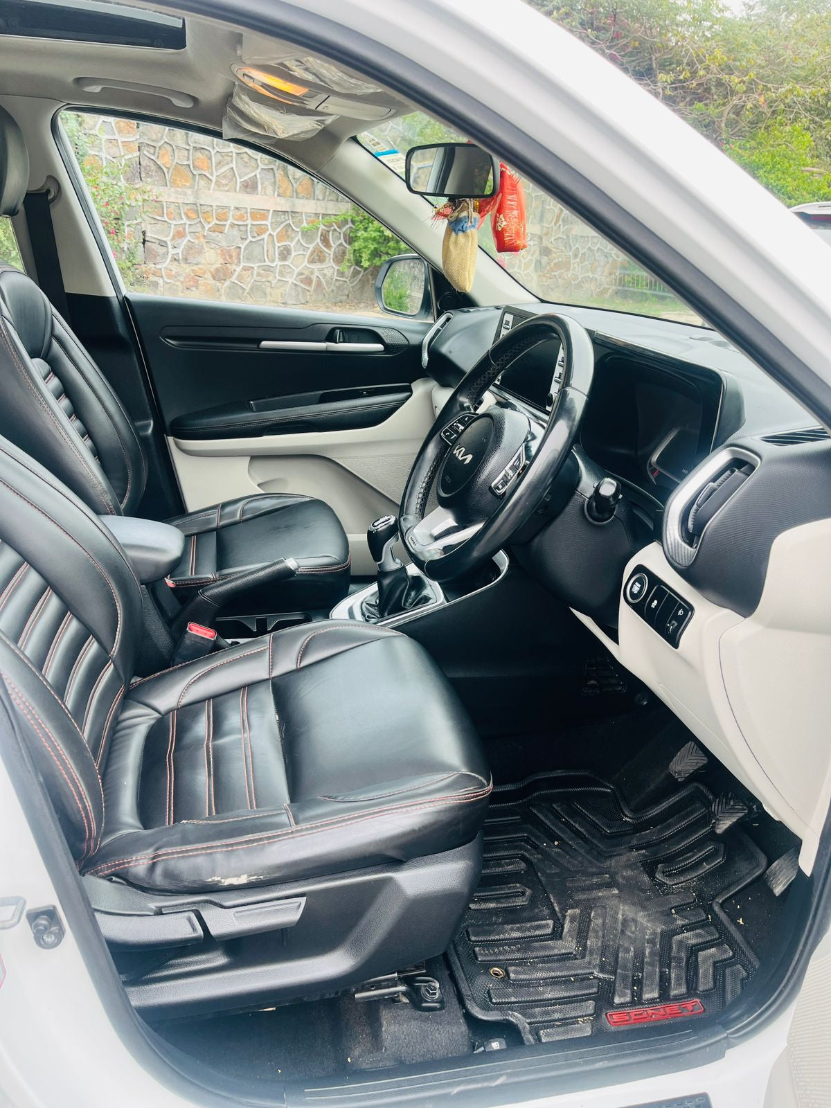 Car interior with black leather seats and dashboard.