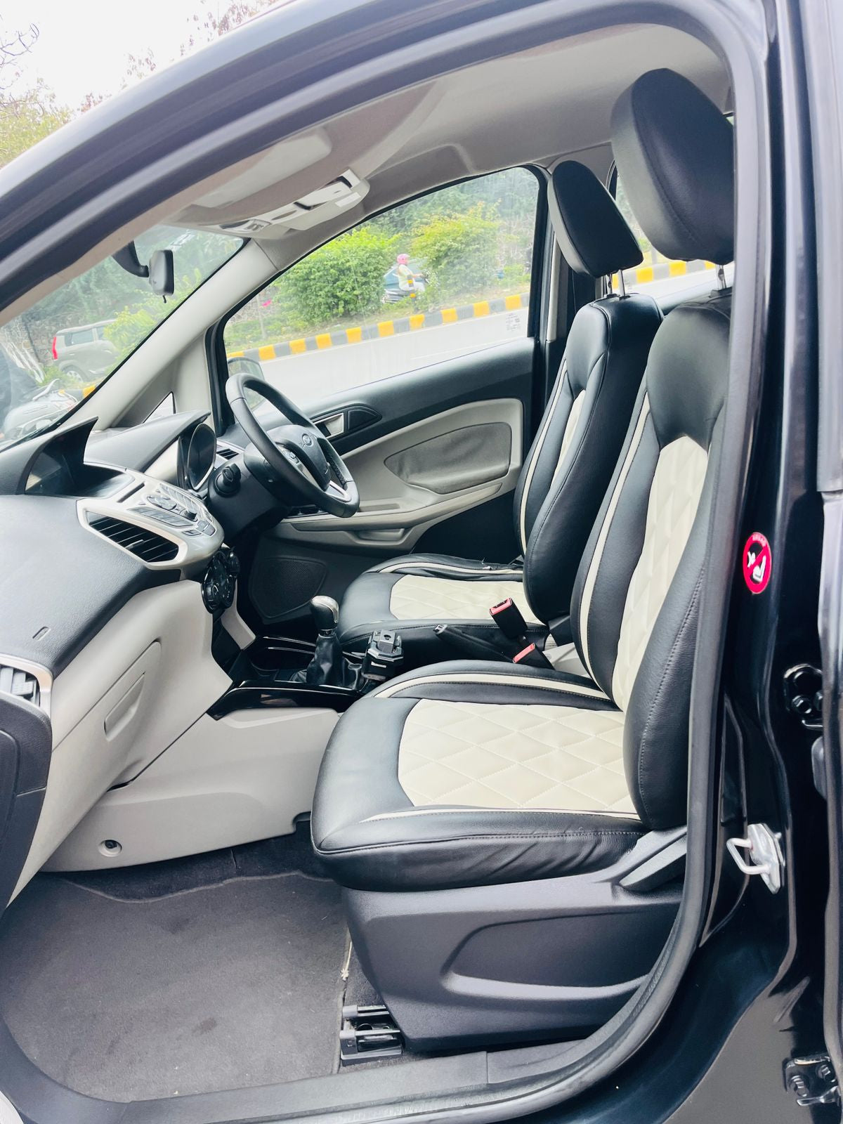 Car interior with black leather seats and dashboard.