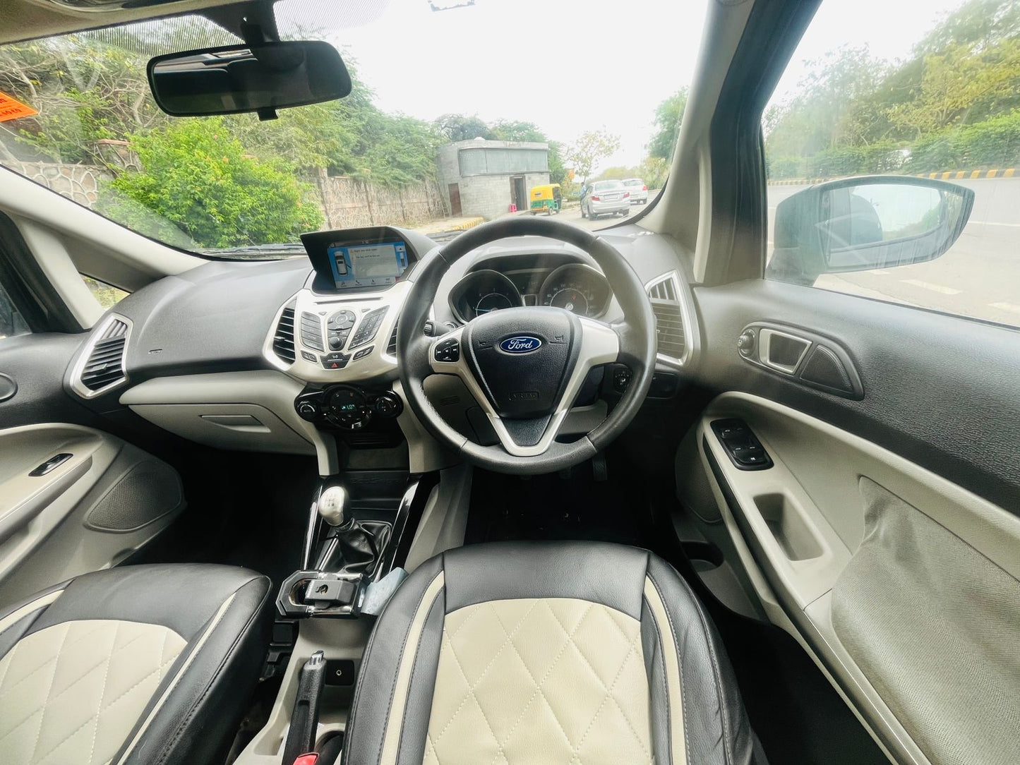 Car interior with steering wheel and dashboard view