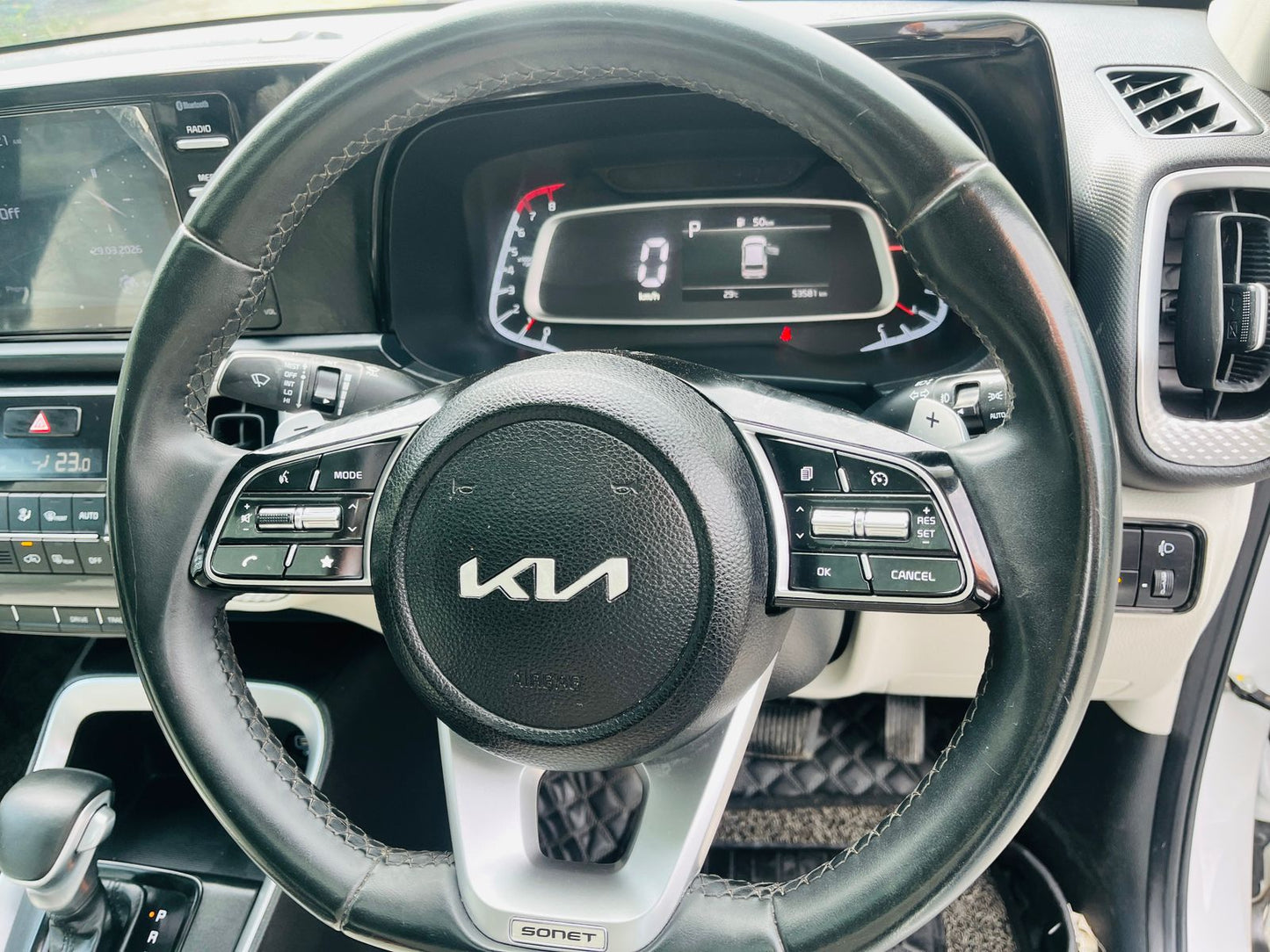 Steering wheel with Kia logo in a car interior