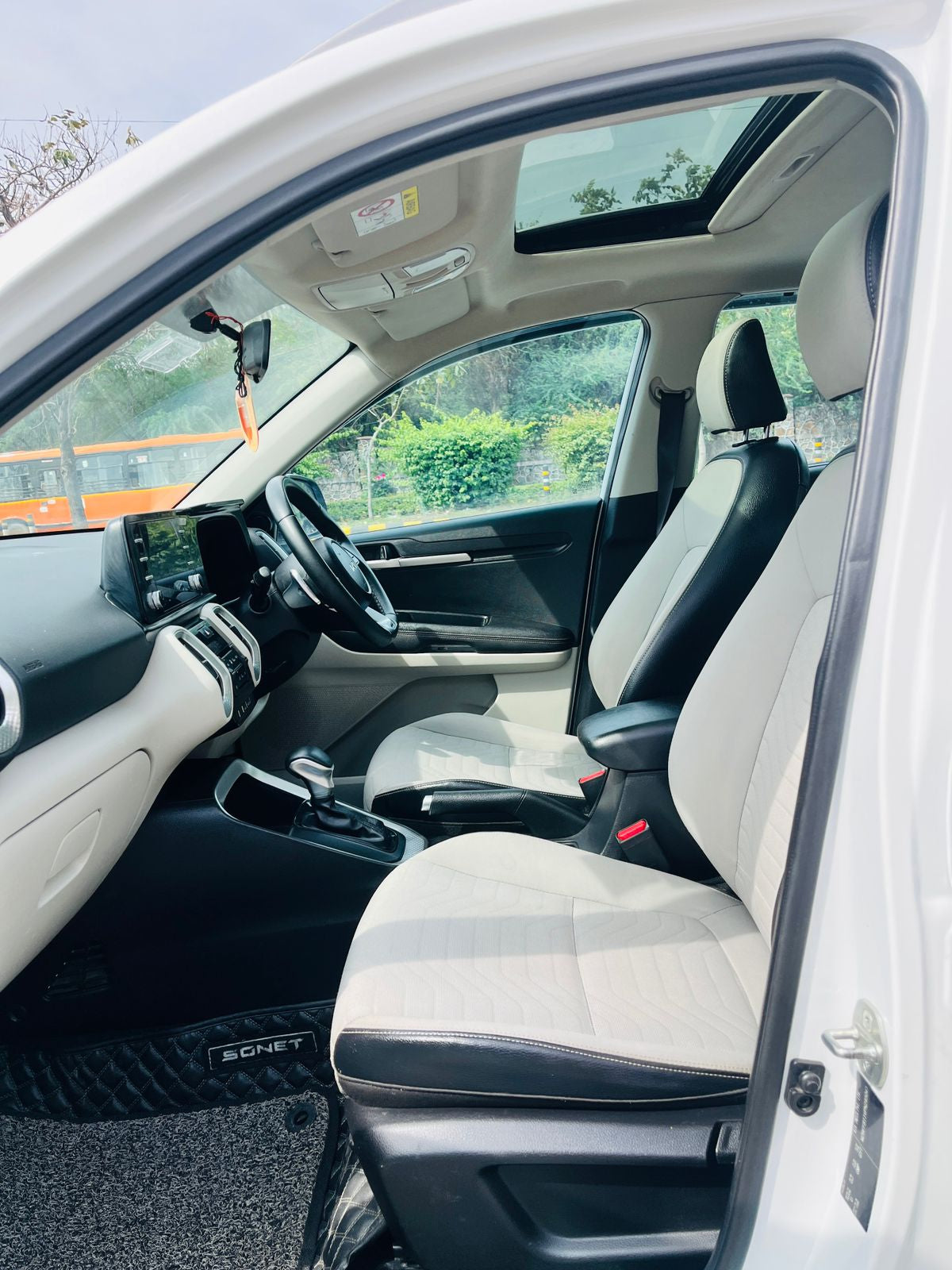 Car interior with a focus on the driver's seat and dashboard.